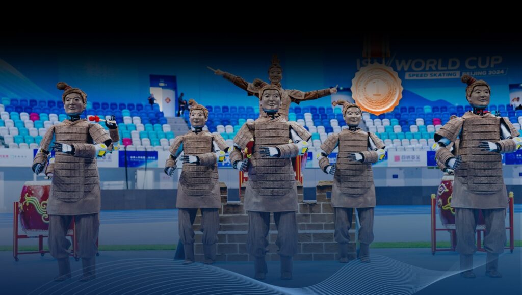 Five humanoid robots in warrior costumes performing on a stadium field, part of a PepsiCo brand activation campaign.